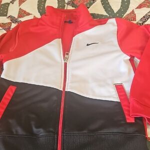A good price  Red, White, and Black Track Jacket with Nike sweat pants.